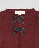 Burgundy knit cardigan with two small metallic contrast bows