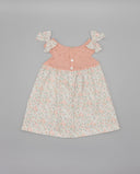 Vestido bebé niña combinado punto rosa salmón y tela floral con lazos y botones nacarados