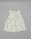 Vestido bebé niña blanco sin mangas estampado floral verde y rosa con volante cruzado en escote y detalle de lazo