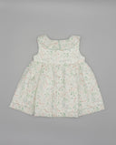 Vestido bebé niña blanco floral sin mangas con cuello volante, estampado hojas verdes y flores rosas, botones nacarados