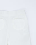 Pantalón bebé blanco roto de popelín con bolsillos decorativos de ondulina y cintura elástica