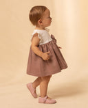 Vestido bebé niña bicolor cuerpo blanco y falda rosa palo con lazo lateral y merceditas rosas a juego