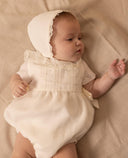 Romper with lace inserts and satin side bows
