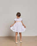 Embroidered plumeti dress with border details and bow