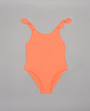 Bañador de una pieza para niña en color naranja neón con tirantes anudados en los hombros