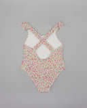 Bañador entero floral rosa y verde con tirantes cruzados en la espalda y detalle de lazos en los hombros